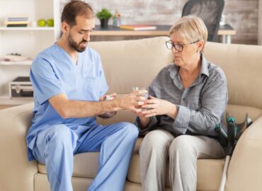 doctor-nursing-home-helping-senior-woman-take-her-medicine (1)