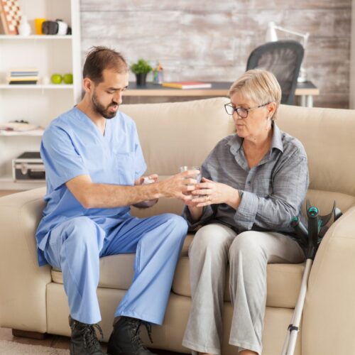 doctor-nursing-home-helping-senior-woman-take-her-medicine (1)
