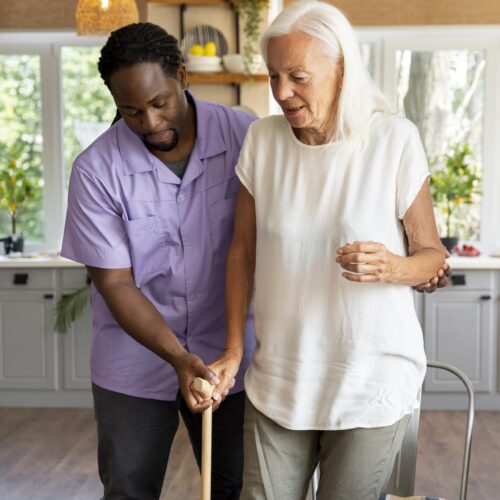 male-social-worker-taking-care-old-woman